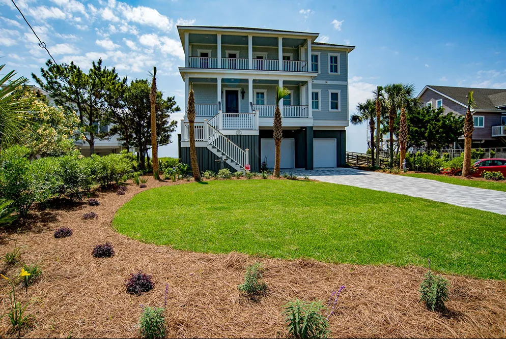 Healthy turf and curved mulch bed installed by Priority Landscaping at a Folly Beach coastal home